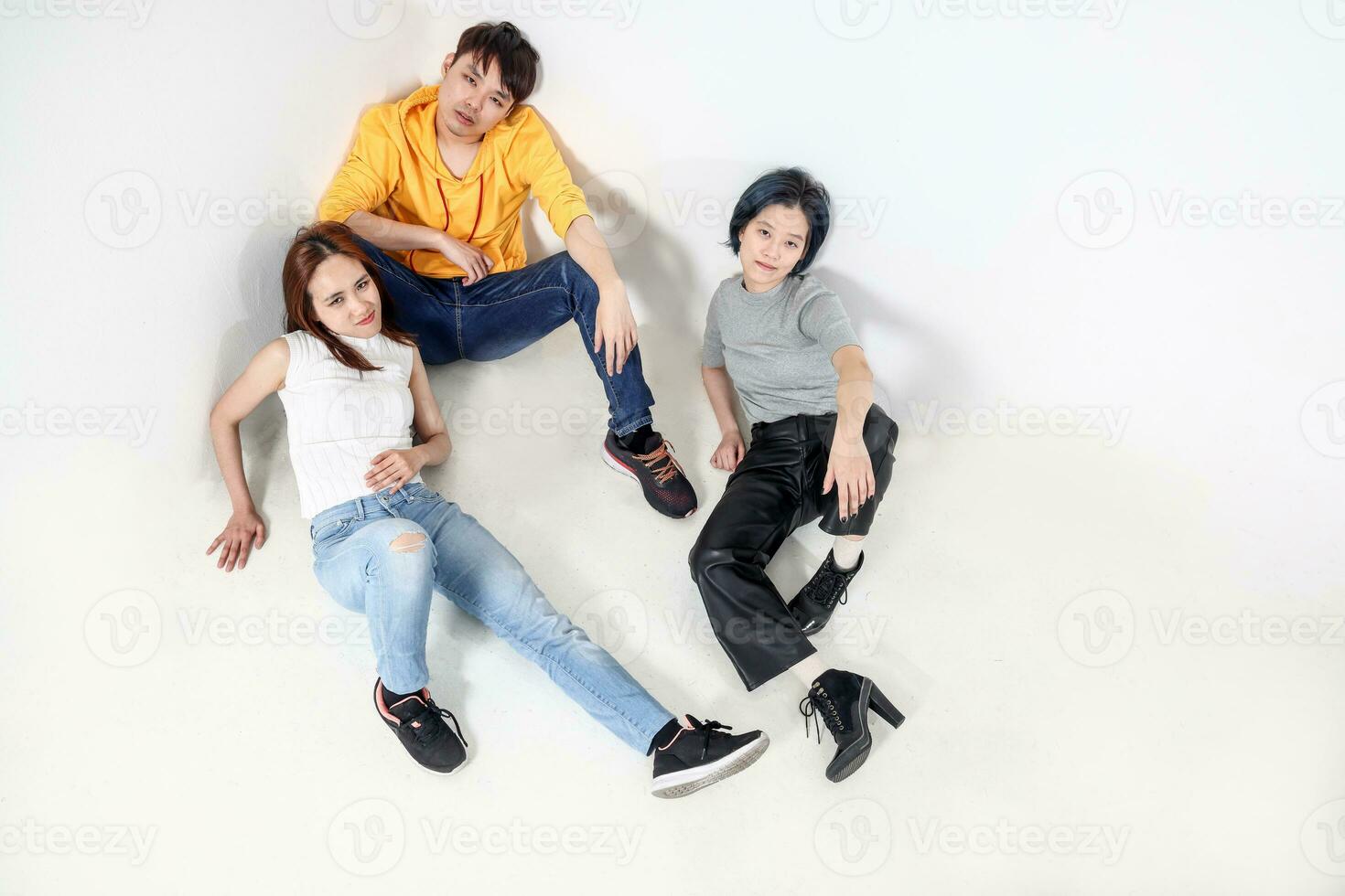 Group of young south east asian mixed woman chinese malay sit laying on white background floor moody tired photo