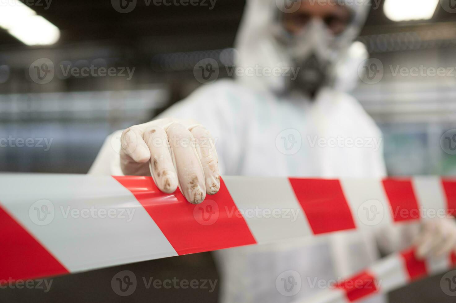 Restricted area, officials employ white and red stripes to block the area where a chemical leak is occurring. To prevent individuals from coming into contact with potentially dangerous chemicals, photo