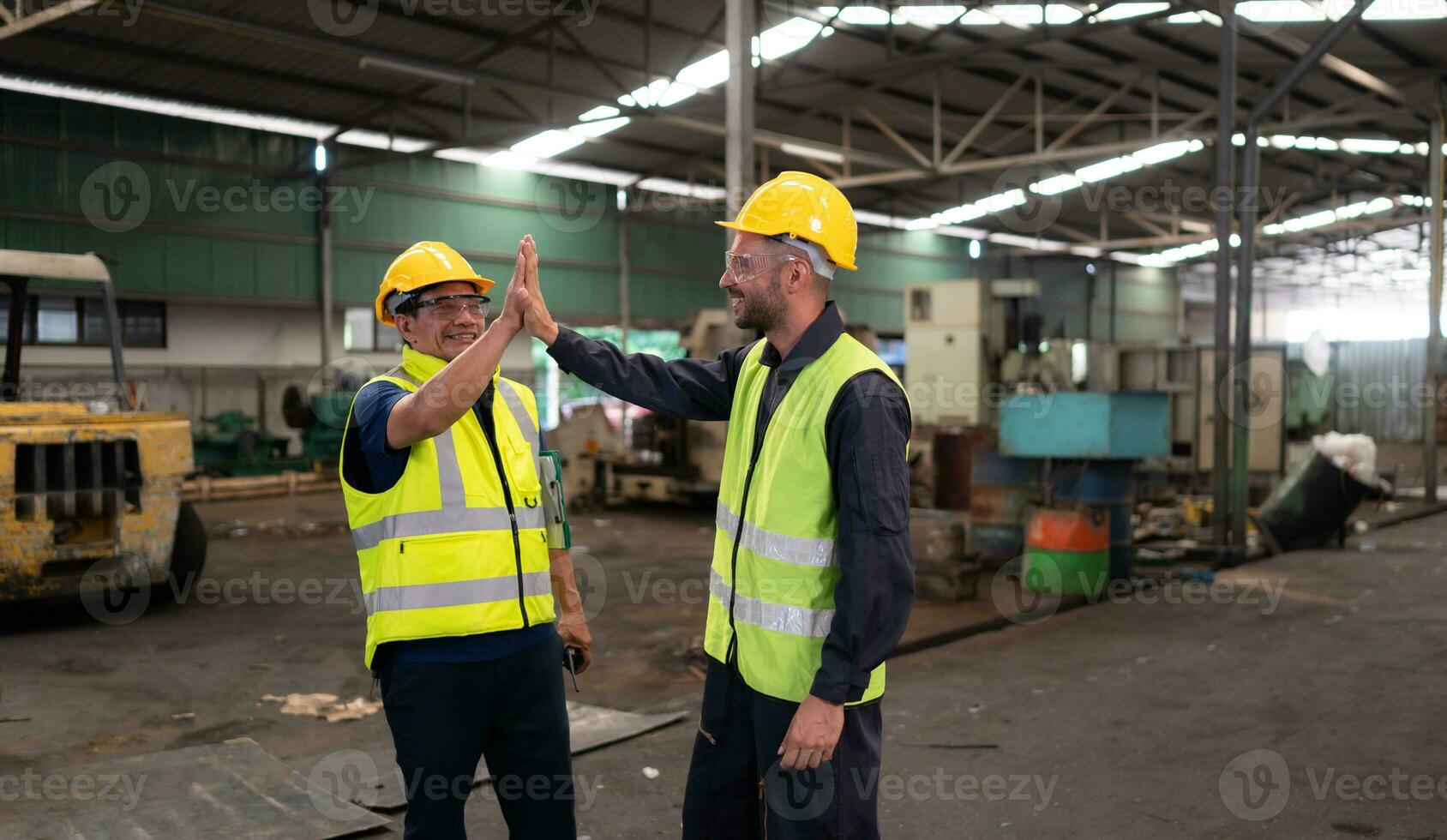 Portrait of technician team leader and team that is ready for repairing old machinery to return to normal operation in the company's old machinery warehouse photo