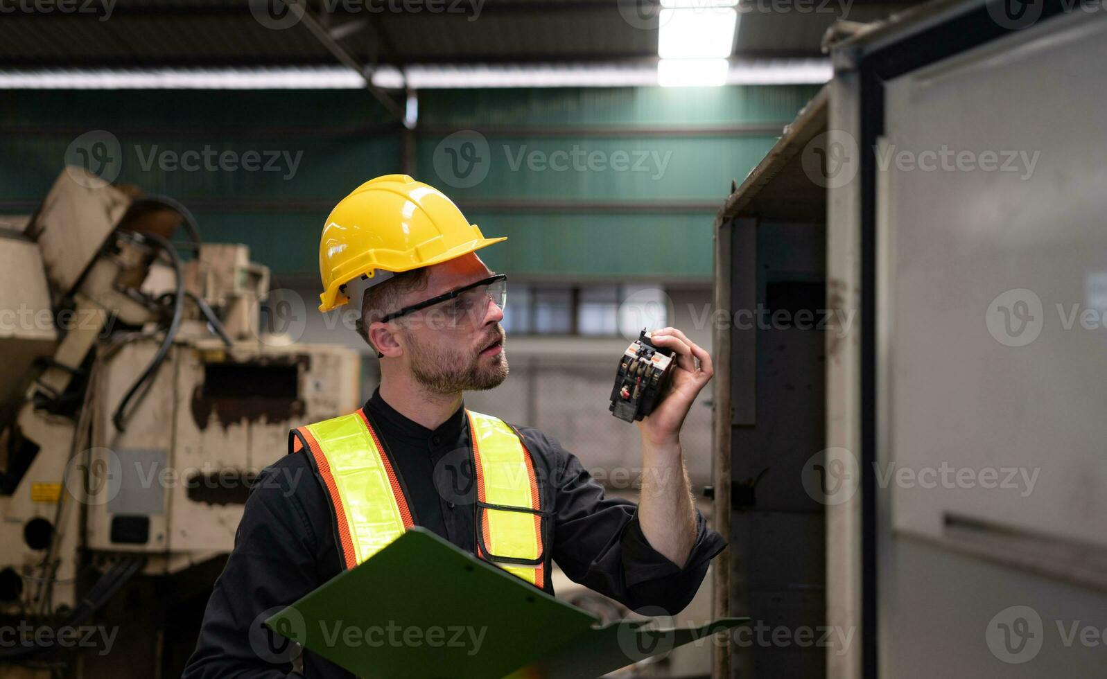 The engineer inspects the electrical system and repairs the mechanical system in the machine control cabinet. in order for the machine to return to normal operation photo