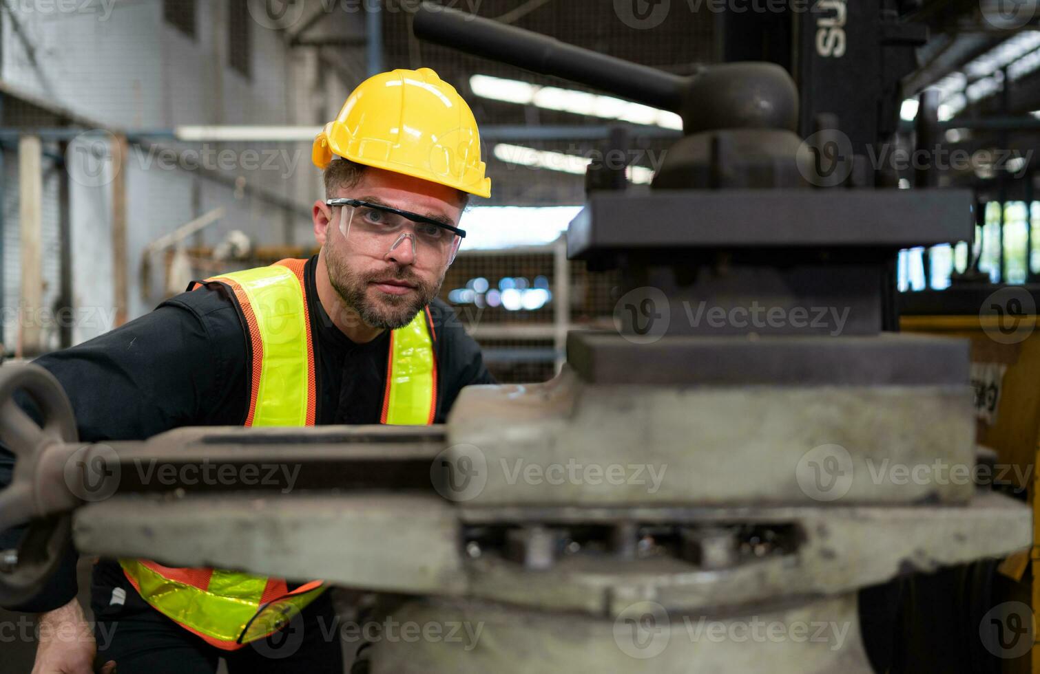 Mechanical engineers enter the old machinery warehouse to inspect and repair used machinery with the warehouse's personnel. photo