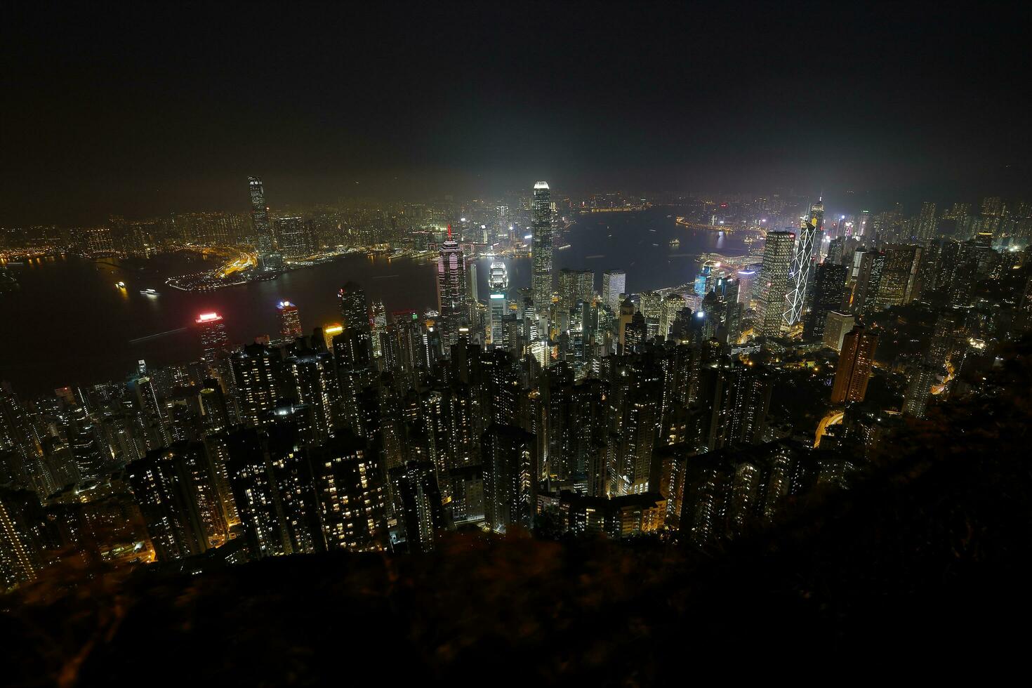 VICTORIA PEAK, HONG KONG- March 12, 2019  Cold foggy evening night view of bustling city Hong Kong from Victoria Peak. photo