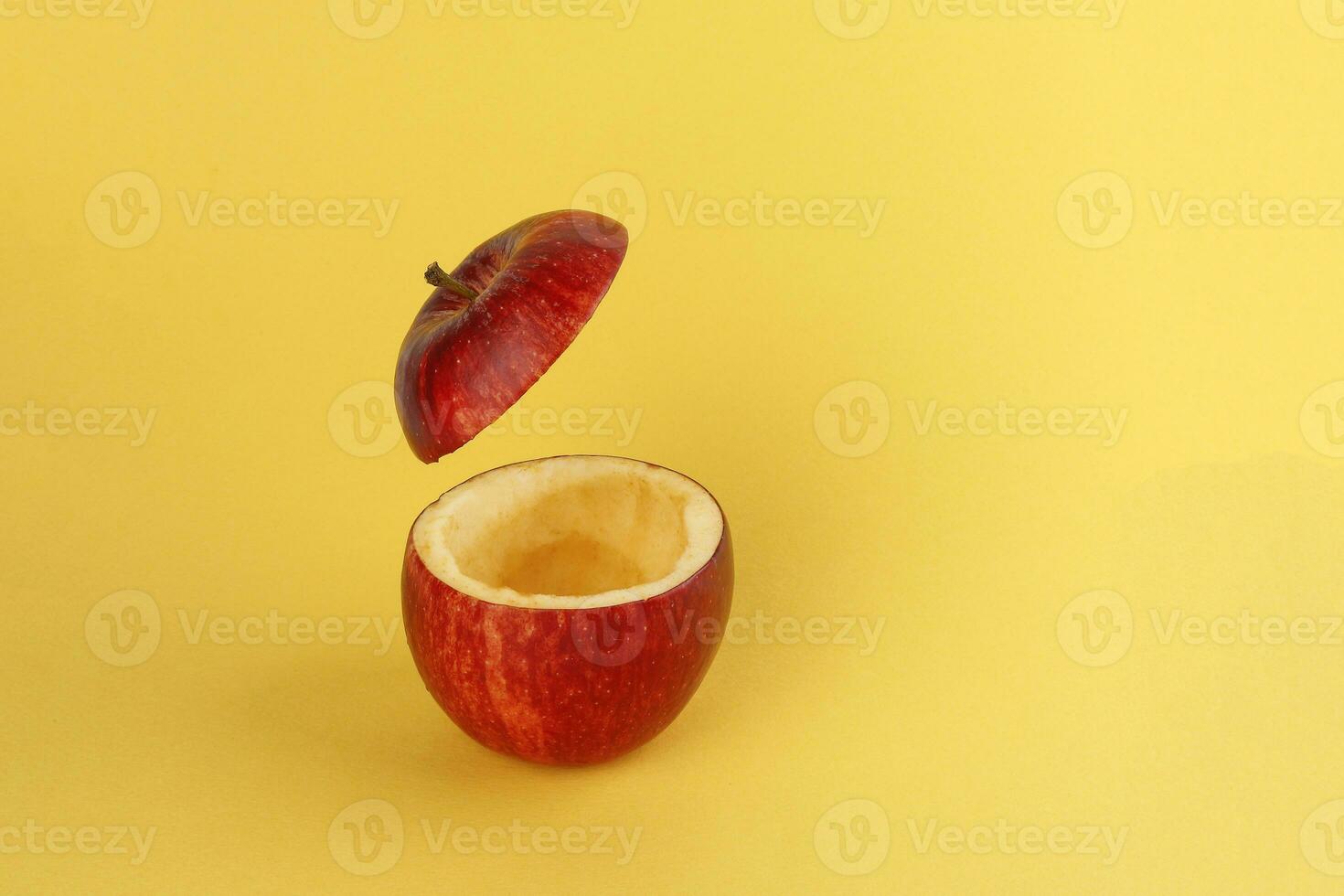 Healthy Red Cut Apple floating top slice juice drink idea concept on yellow background photo