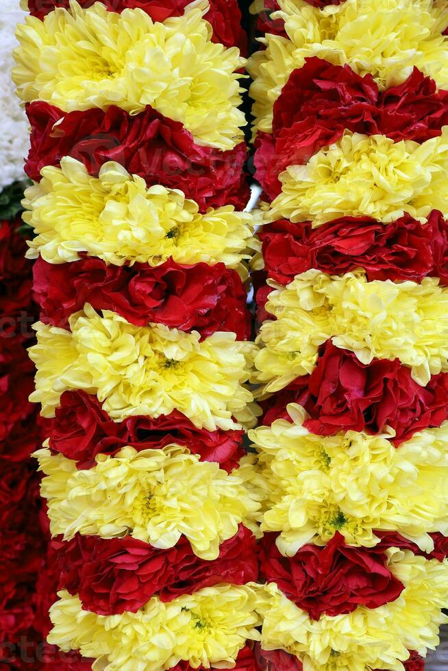 Yellow red color flowers garland for temple worship offering photo