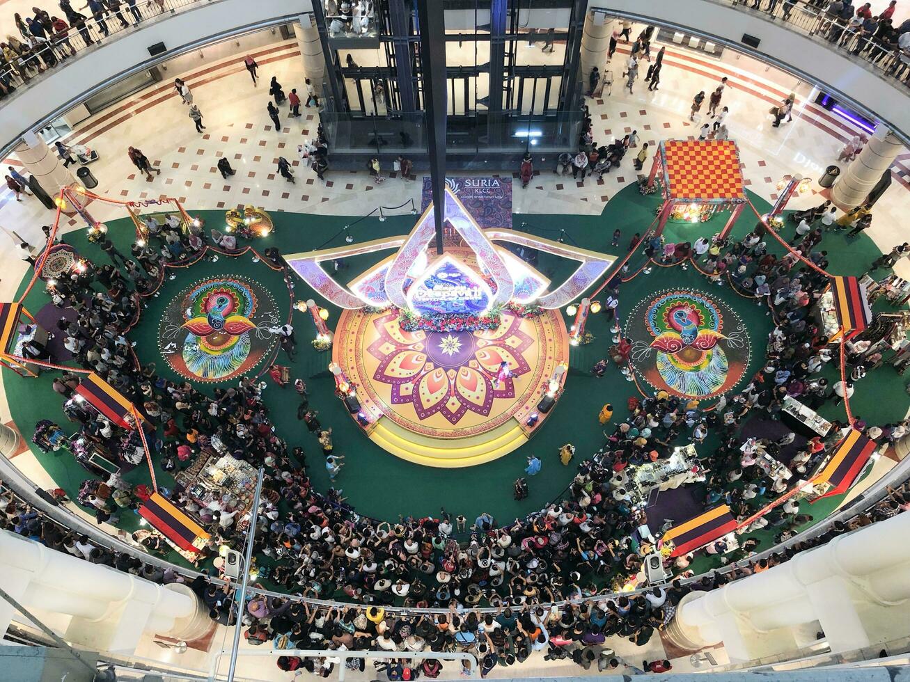 Kuala Lumpur, MALAYSIA November 1, 2018 The crowd watching dance on stage and the Kolam or rice art for Hindu festival of  Deepavali at KLCC Mall. photo