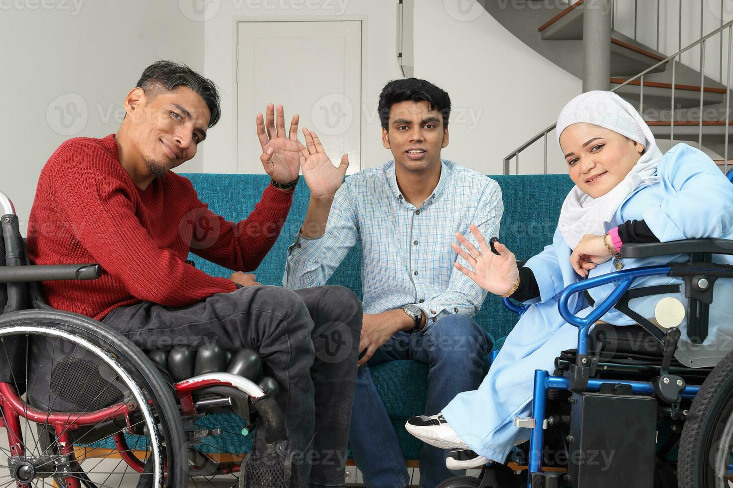 Portrait of young man and woman talking discussing work business. Two on wheelchair are paralyzed and one sitting on sofa adhd also Autism autistic photo