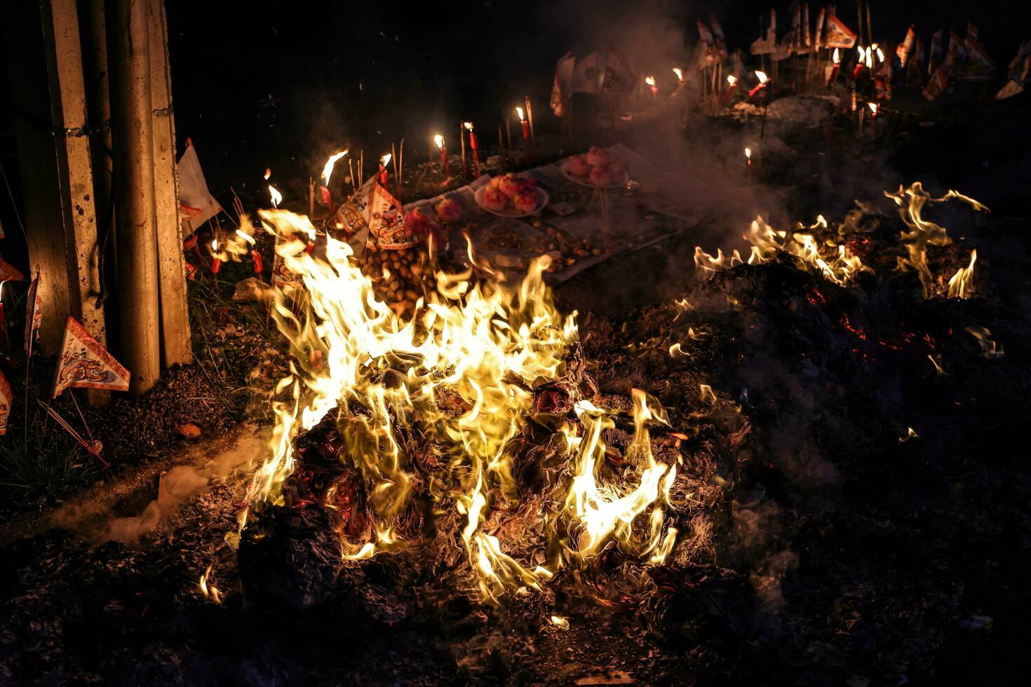Chinese hungry ghost festival burning flame fire glowing ashes firefly colourful variety prayer paper joss money fake currency joss stick mini fag food fruit photo