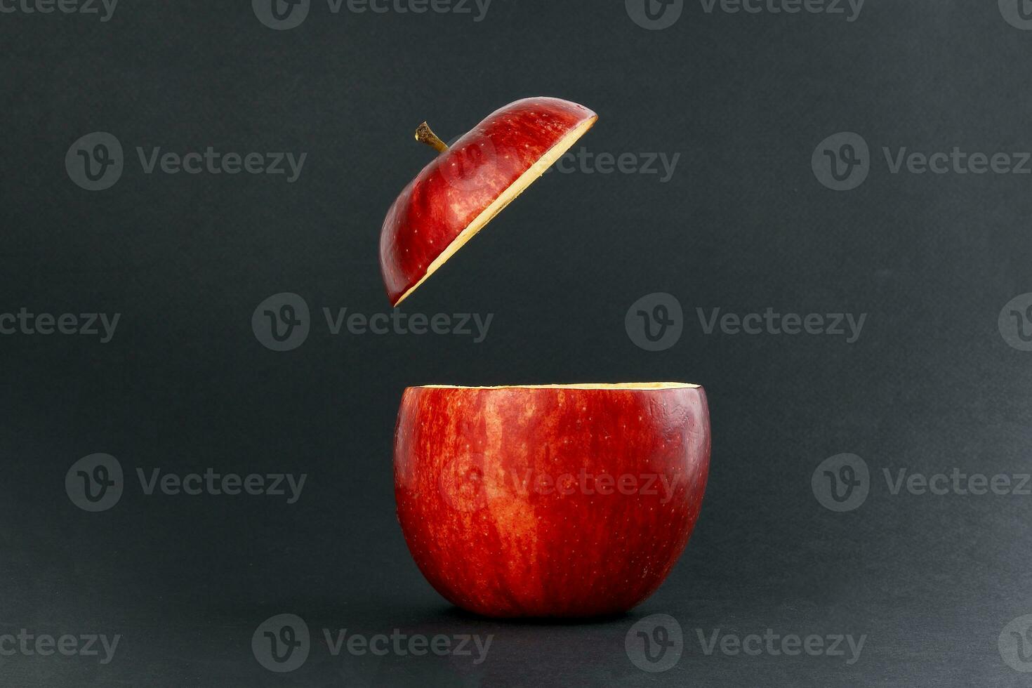 Health Red Cut Apple floating top slice juice drink idea concept on black background photo