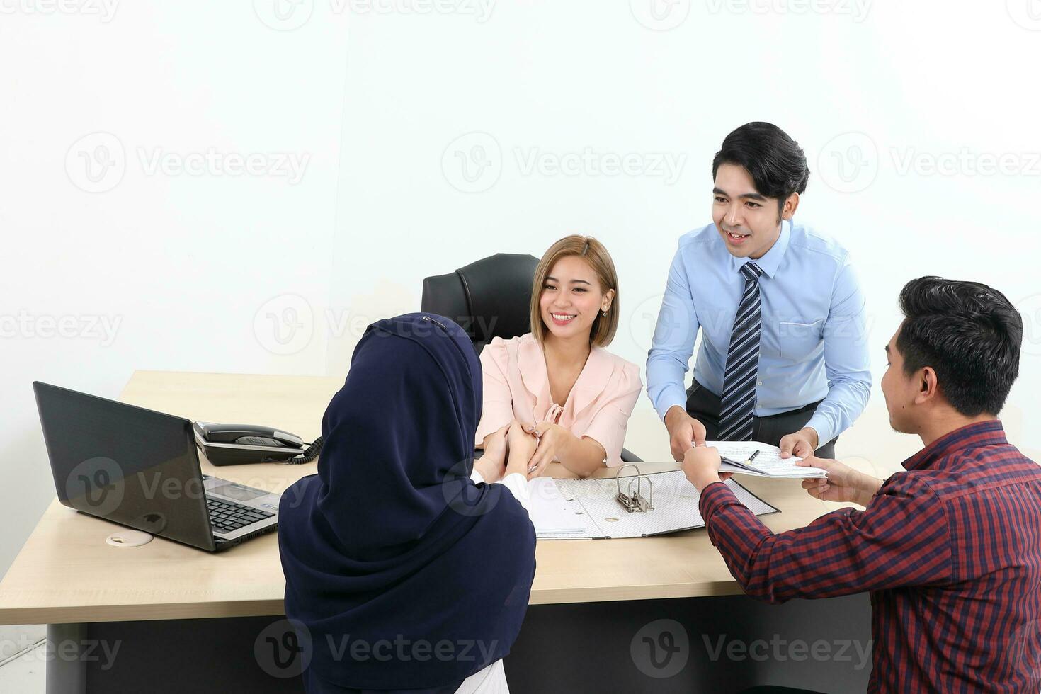 Asian young man woman malay chinese office table sit stand client couple meeting talk discuss show see point explain file document folder photo