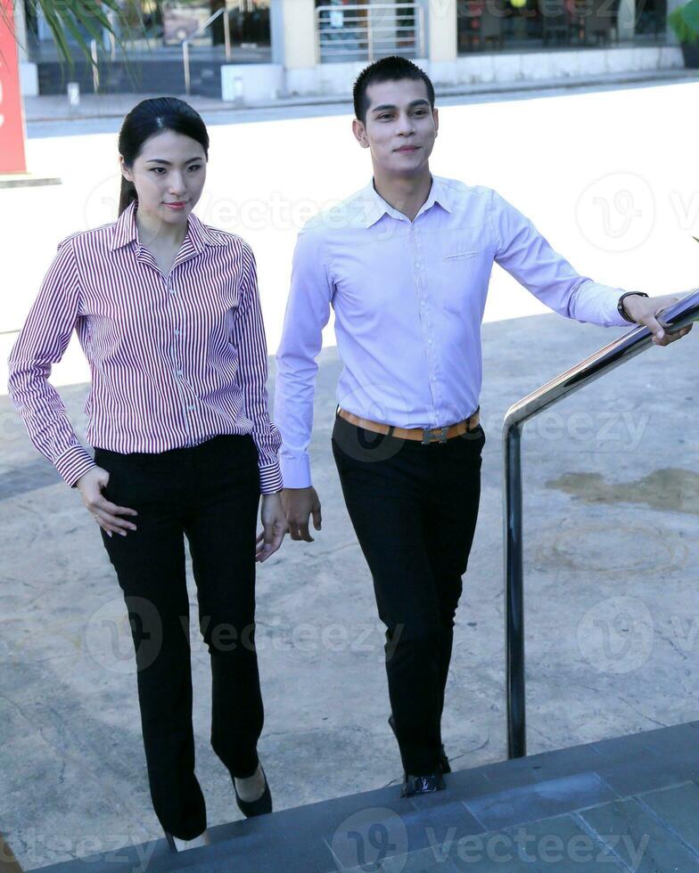Young south east Asian middle eastern man woman business colleague outdoor stand pose photo