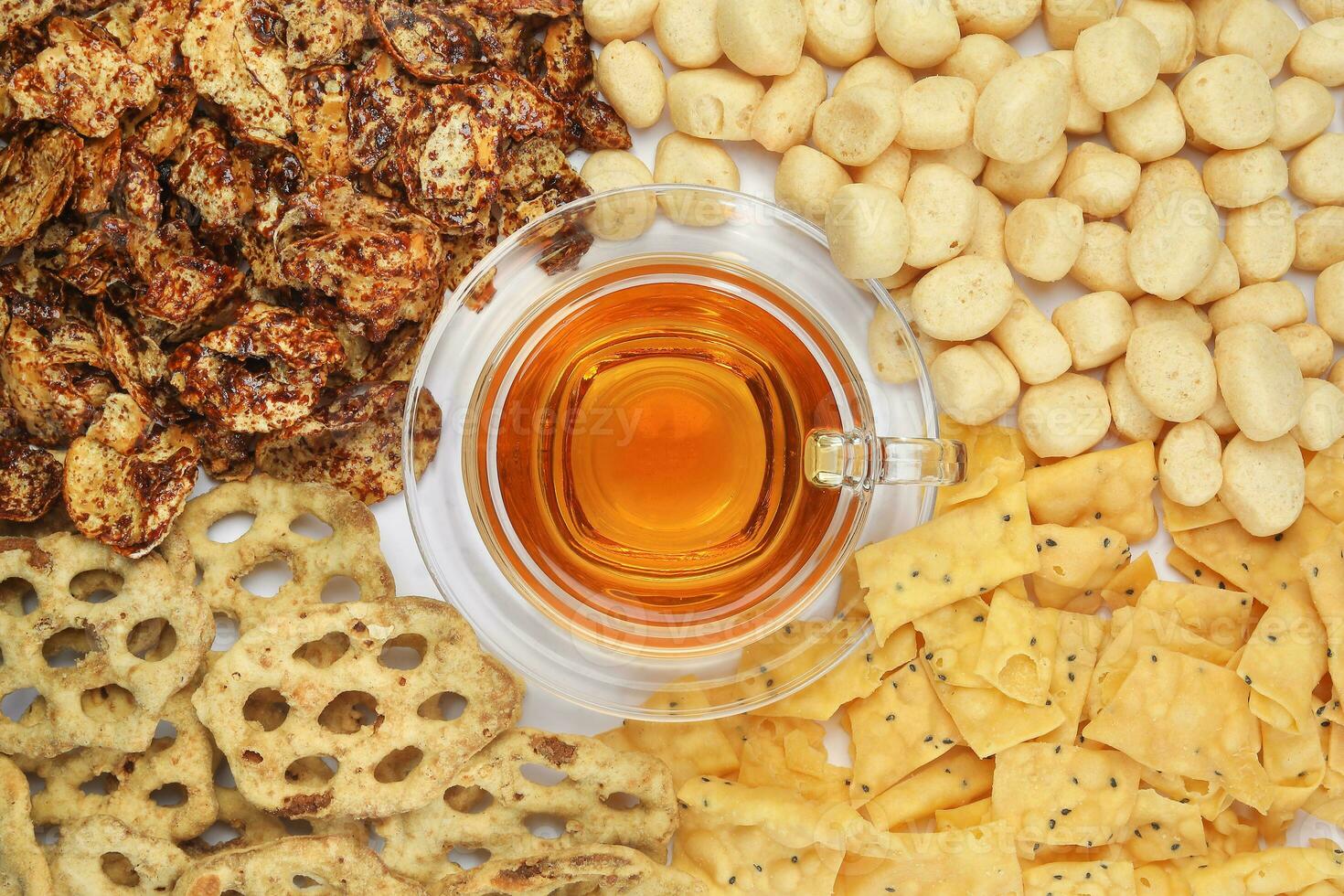 Amplang Belinjo chips Kuih Cincin rice flower brown sugar sweet cracker Keropok Tauhu tofu flower few favourite Sabah Borneo tea time snacks nimki with cup of transparent licker tea photo