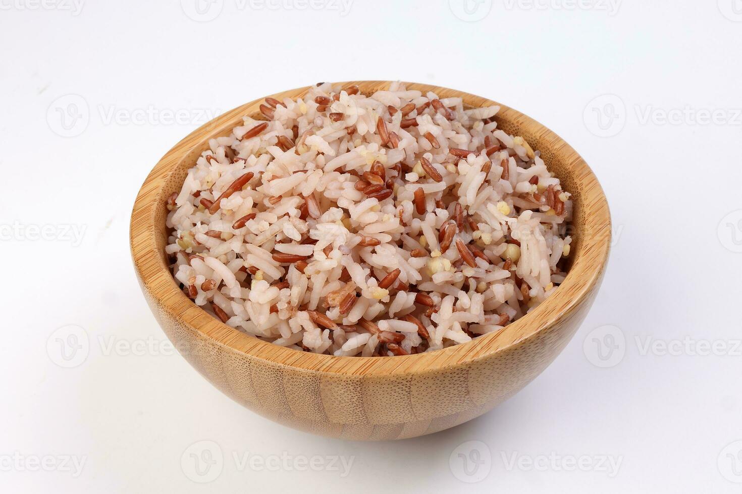 Cooked mixed low glycaemic index healthy rice grain basmati millet buckwheat red rice in wooden bowl on white background photo