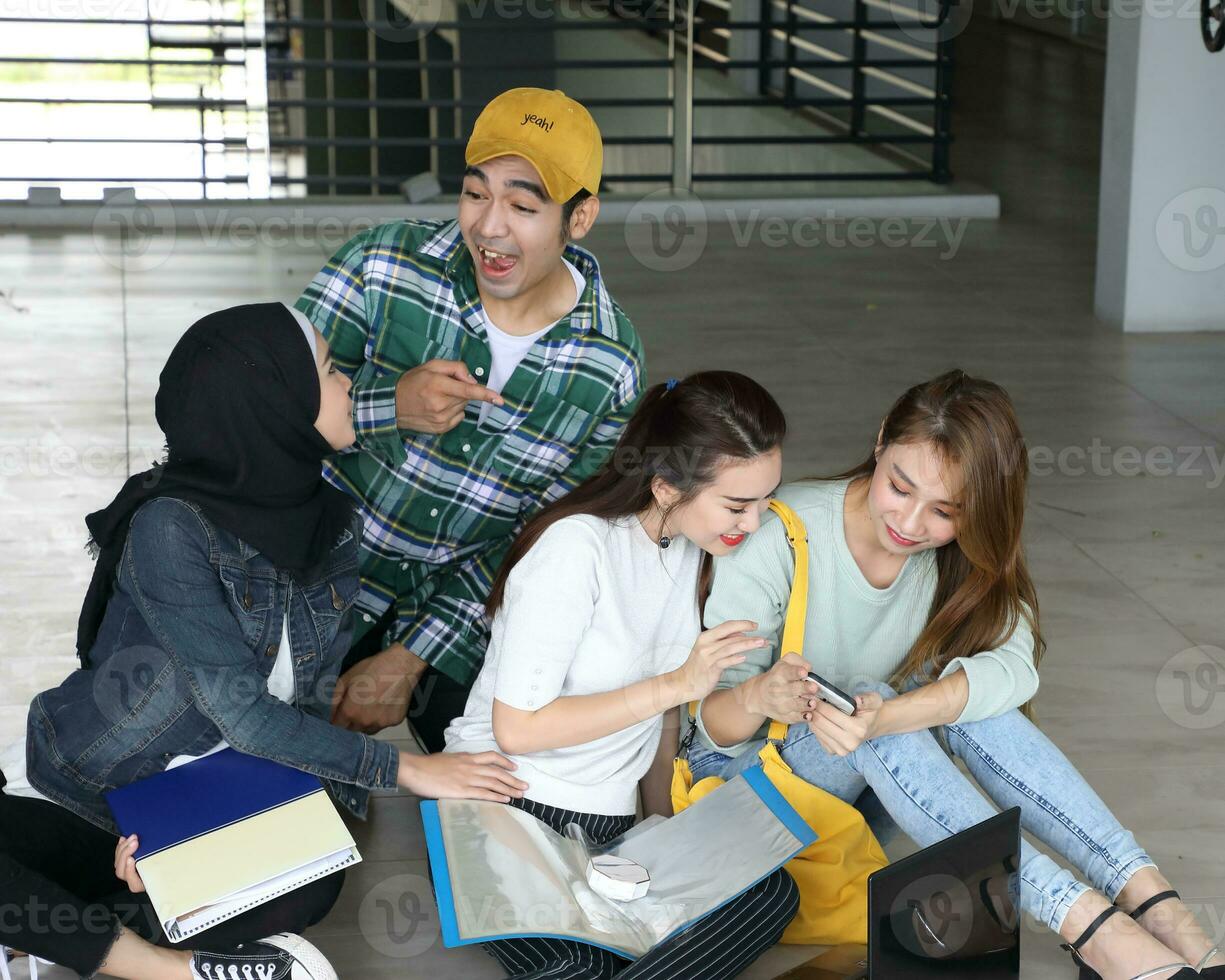 Young asian malay chinese man woman indoor stair corridor campus book file folder laptop computer phone sit stand study mingle photo
