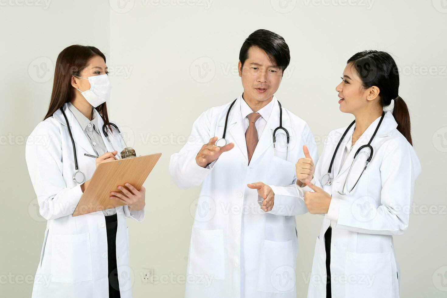 Young Asian male female doctor wearing apron stethoscope talk discuss photo