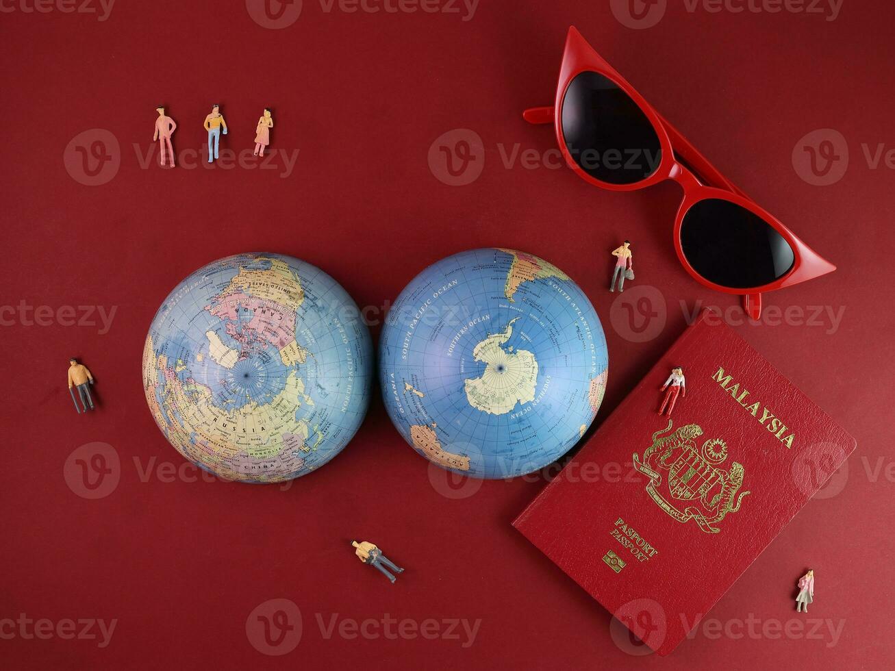 Vaccine passport Malaysia red sunglass world atlas globe map north south pole on red paper background world travel tour vacation mini human figures medical needle syringe bottle photo