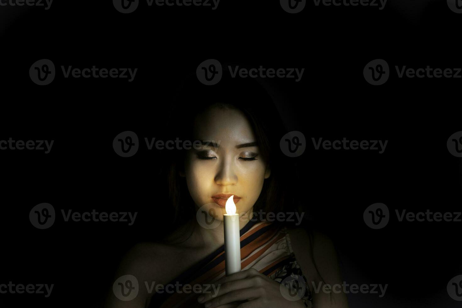 Asian face light woman candles light magical mystic dark background photo