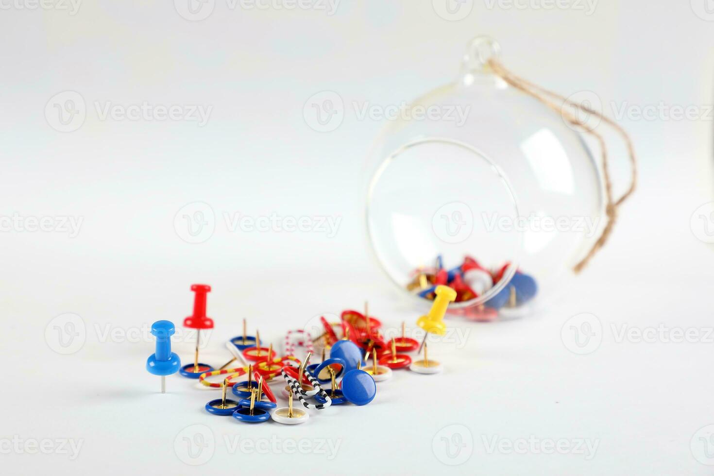 Colorful board pin on white background glass jar bowl photo