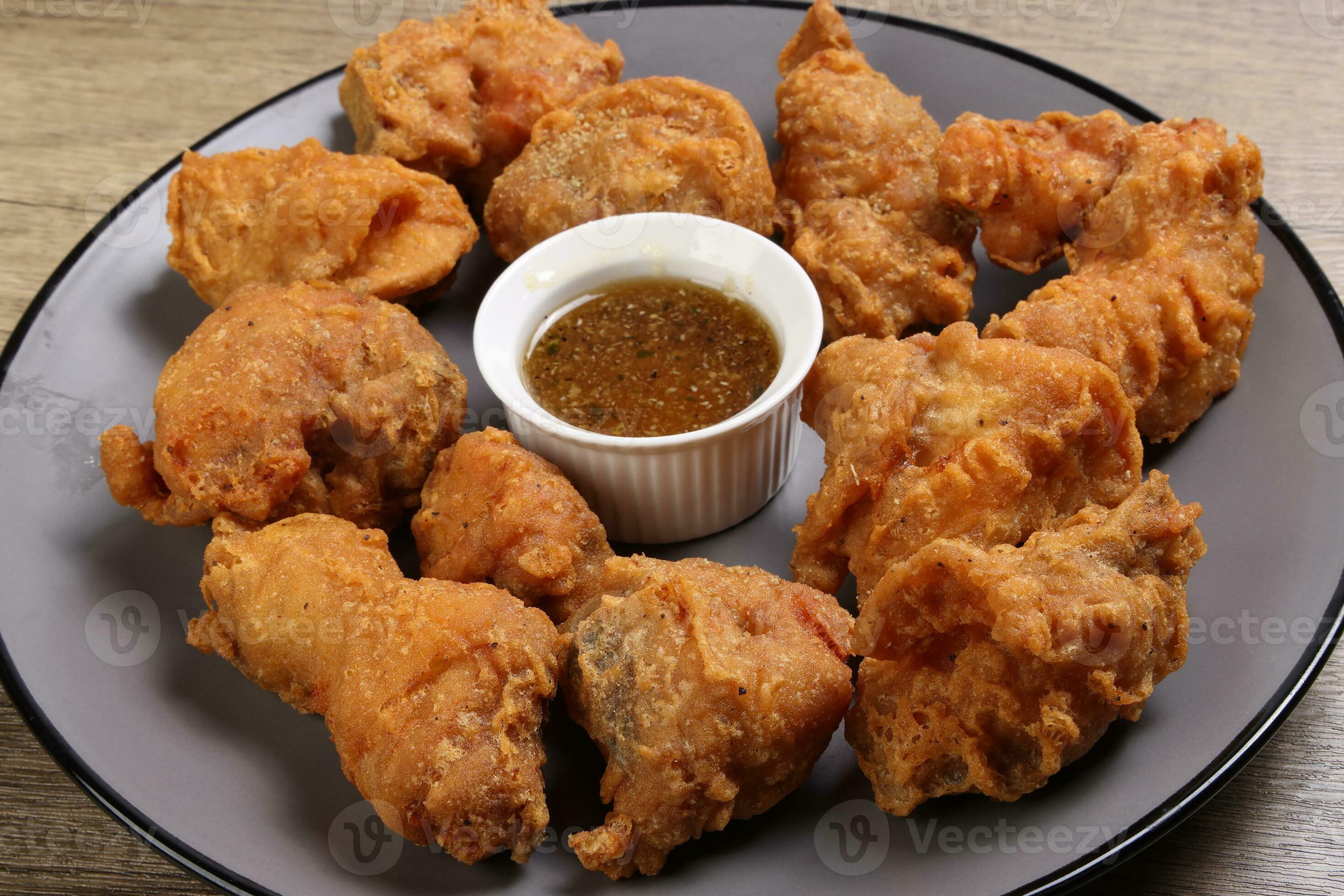 Light battered deep fried chicken variety mix pieces pile flaky meat on