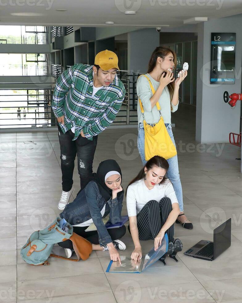 Young asian malay chinese man woman indoor stair corridor campus book file folder laptop computer phone sit stand study mingle photo