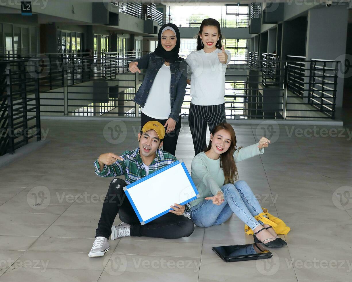 Young asian malay chinese man woman indoor stair corridor campus book file folder laptop computer phone sit stand study mingle photo