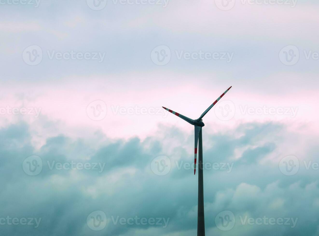 Wind farm or windmill in cloudy weather in Austria in Europe, allows you to get clean energy. It's sustainable, renewable energy for the environment photo