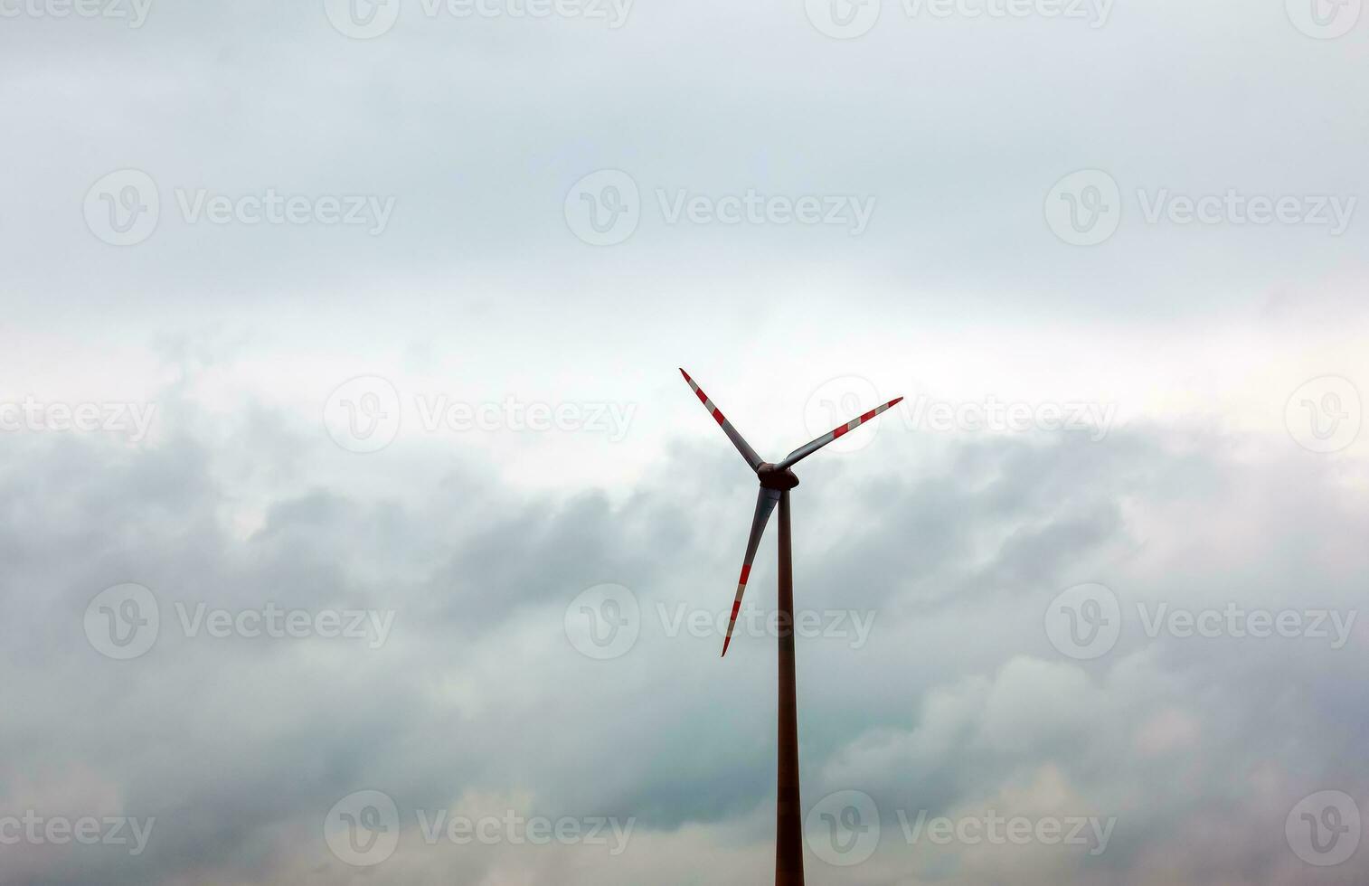 Wind farm or windmill in cloudy weather in Austria in Europe, allows you to get clean energy. It's sustainable, renewable energy for the environment photo