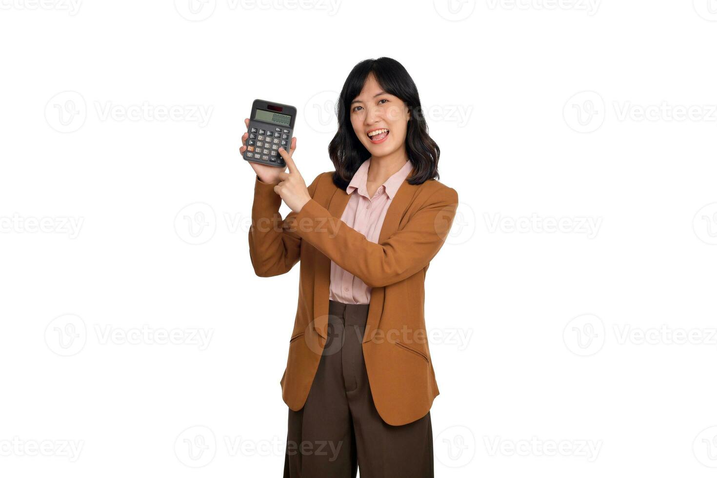 Tax day concept. Asian woman confident smiling holding calculator and finger point device, Portrait happy Asian female isolated on white background, Account and finance counting income photo