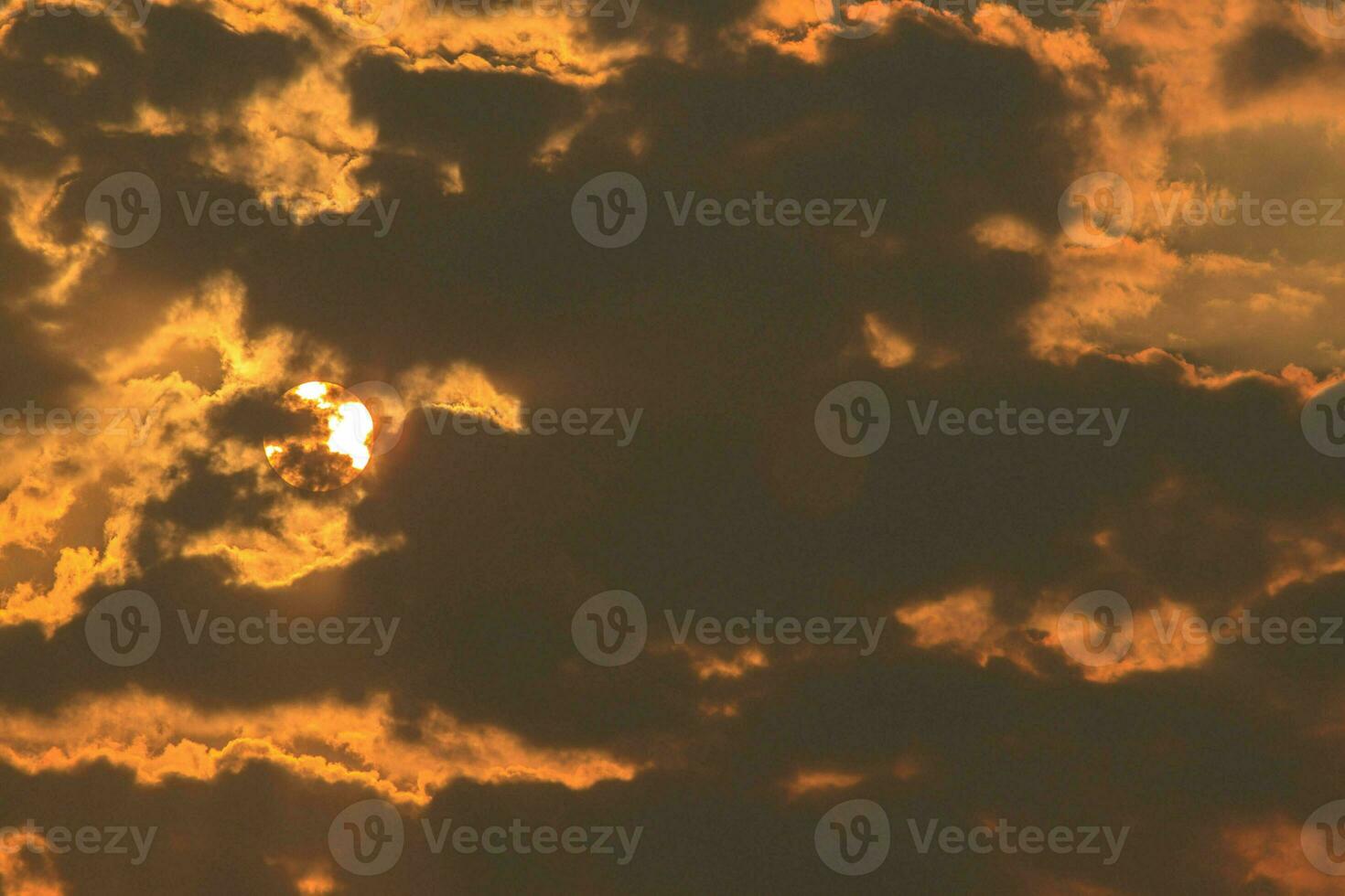 sun was behind the clouds in the evening, causing the light to scatter and the splashes of nature to create a fiery and terrifying look. photo