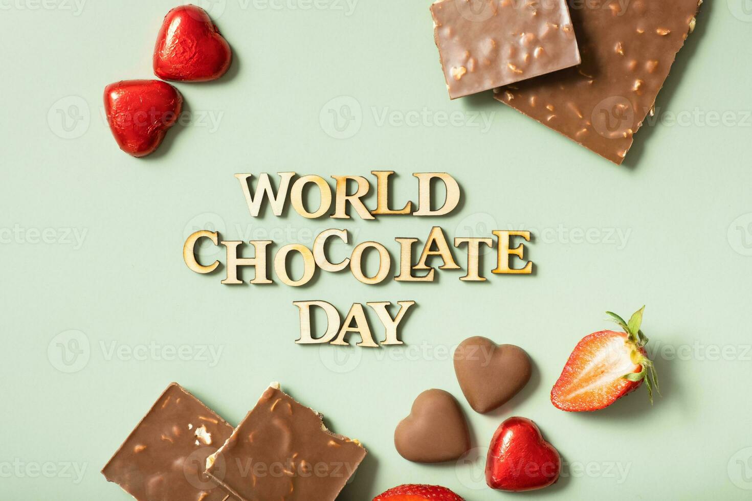 World chocolate day text with chocolate flat lay, top view on pastel green background photo