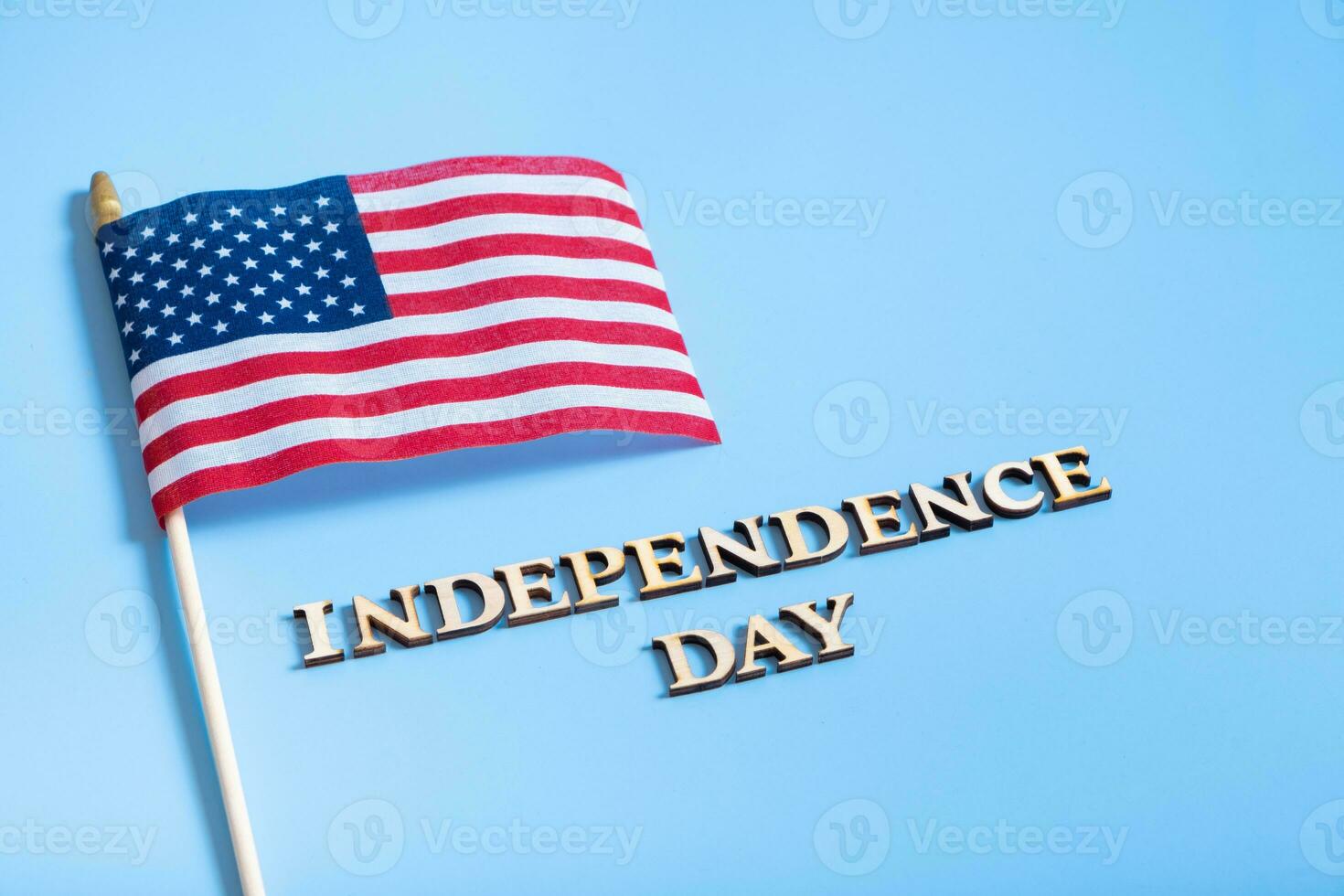 Independence day text with USA flags top view, flat lay on white background photo