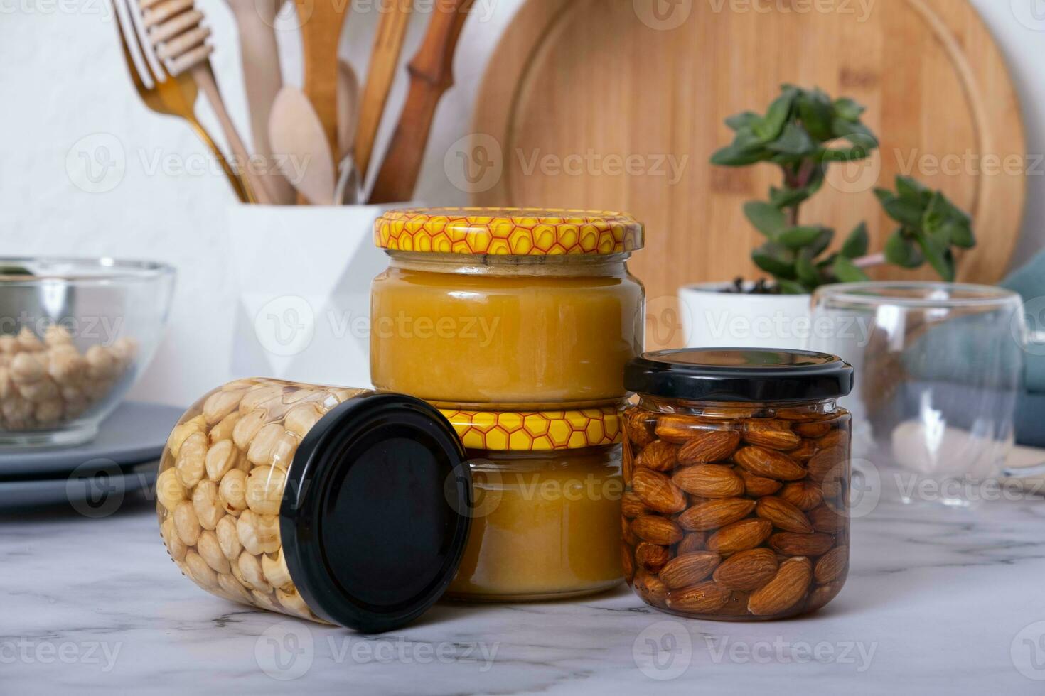 Glass jars with honey and nuts. Almonds and hazelnuts in honey in