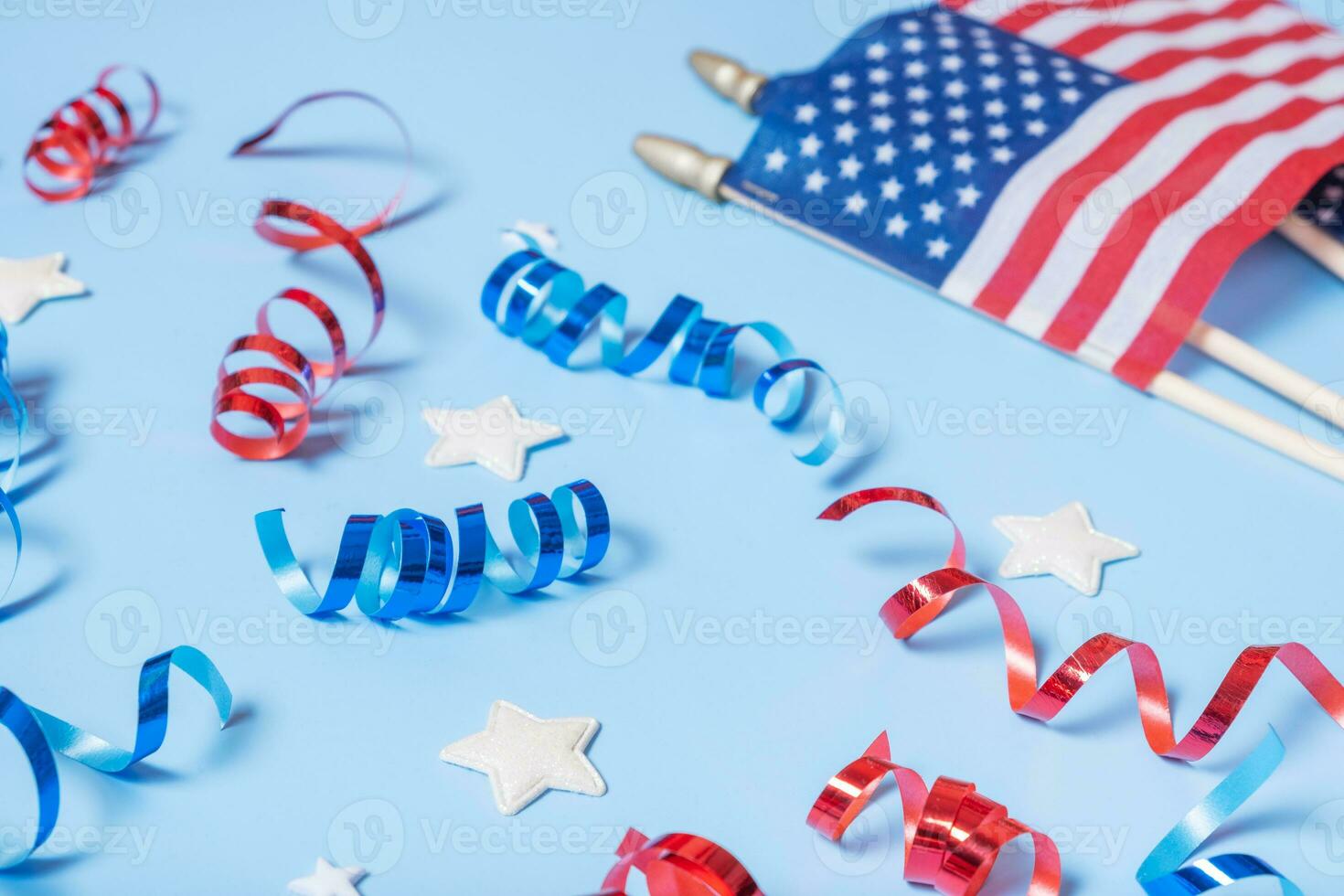 USA Independence day concept. Red and blue spirals and white stars elements of USA flag top view, flat lay on blue background photo