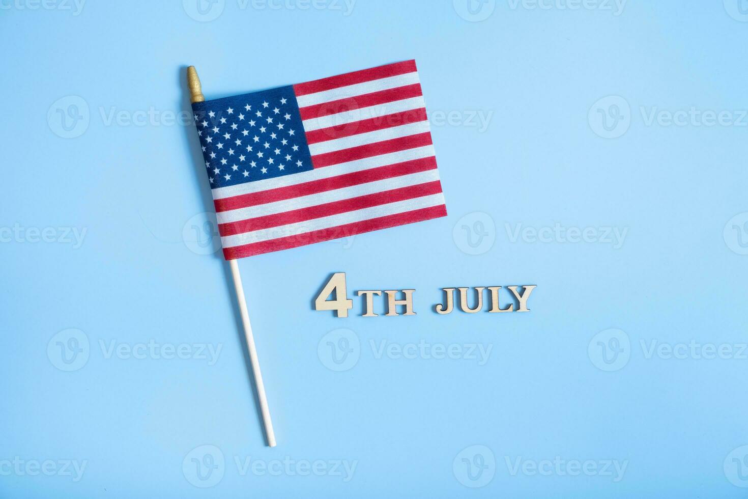 Independence day text with USA flags top view, flat lay on white background photo