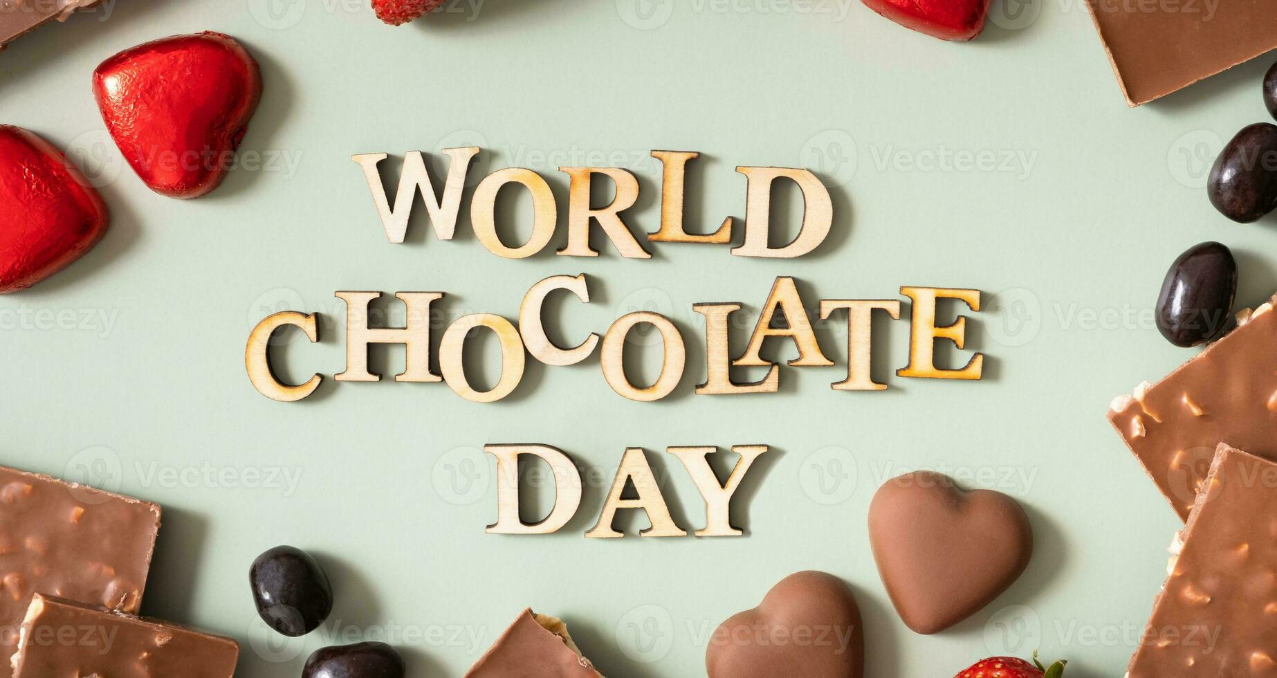 World chocolate day text with chocolate flat lay, top view on pastel green background photo