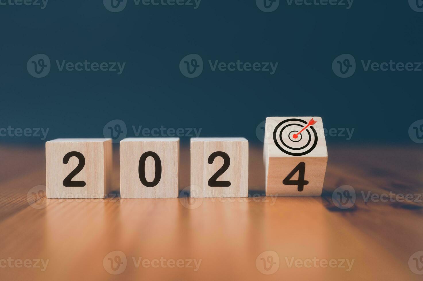 wooden cubes with the text  2024 and virtual arrow dart board  over background photo