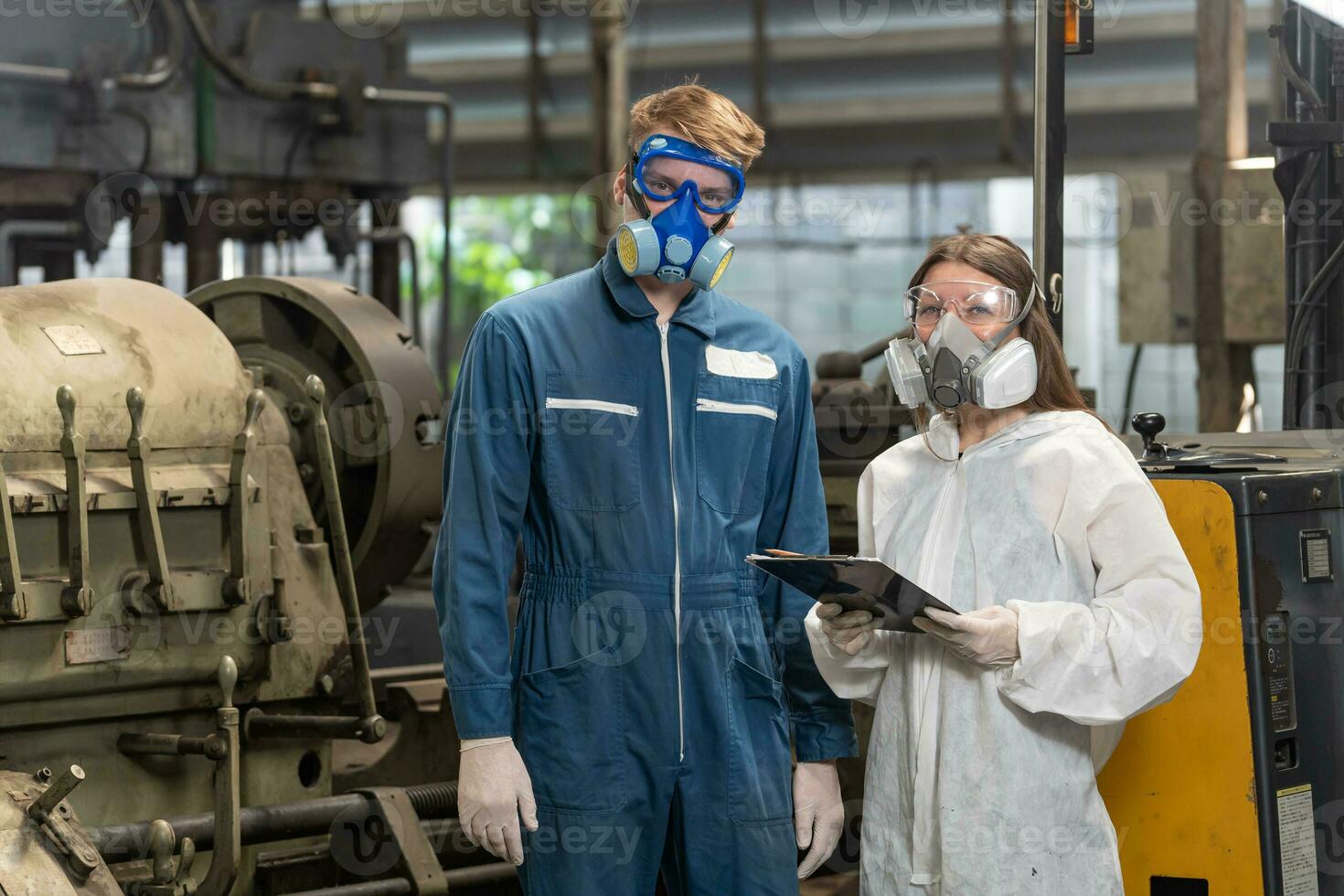 emergency pollution factory concept. Portrait engineer wearing a mechanical jumpsuit and gas mask looking at the camera with his arms crossed. photo