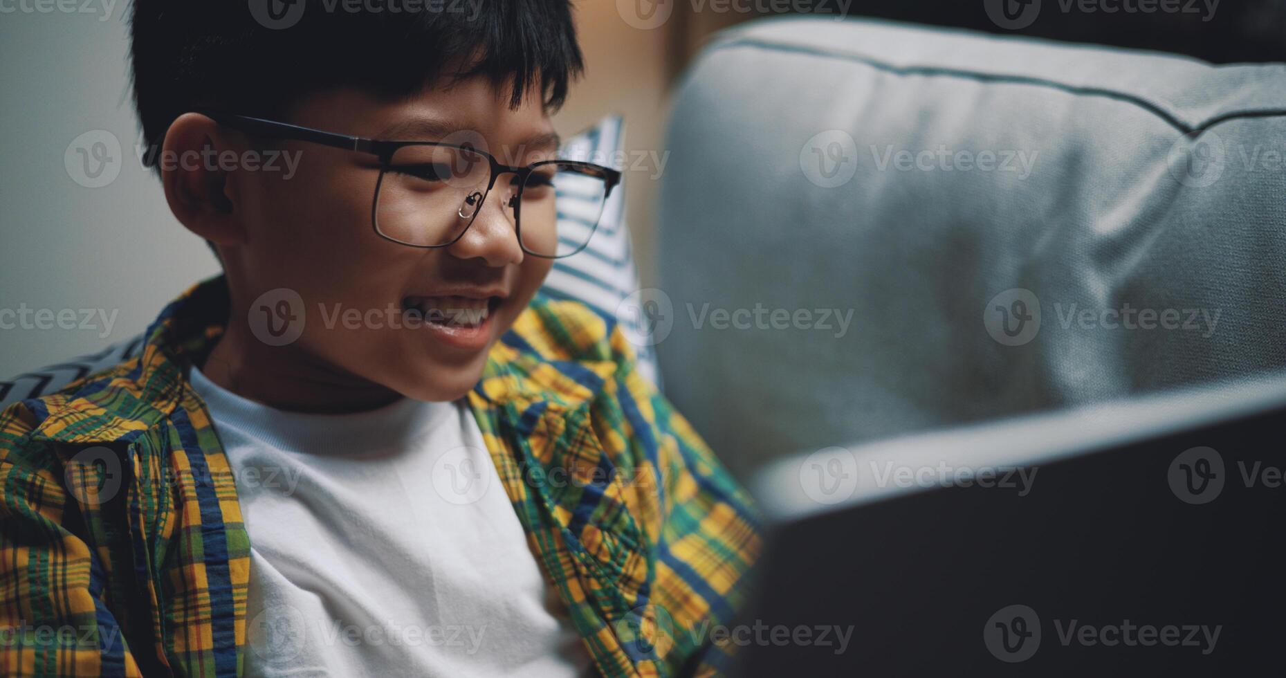 Smart boy use laptop computer to learning online at home photo
