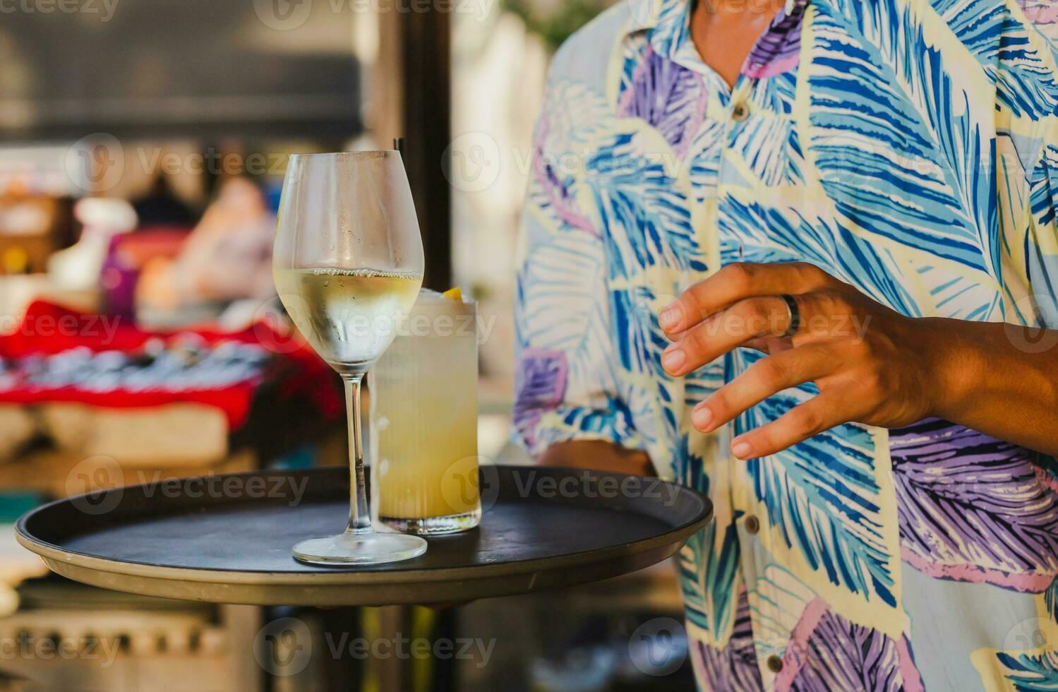Waiter serving glass of white wine by the glass. photo