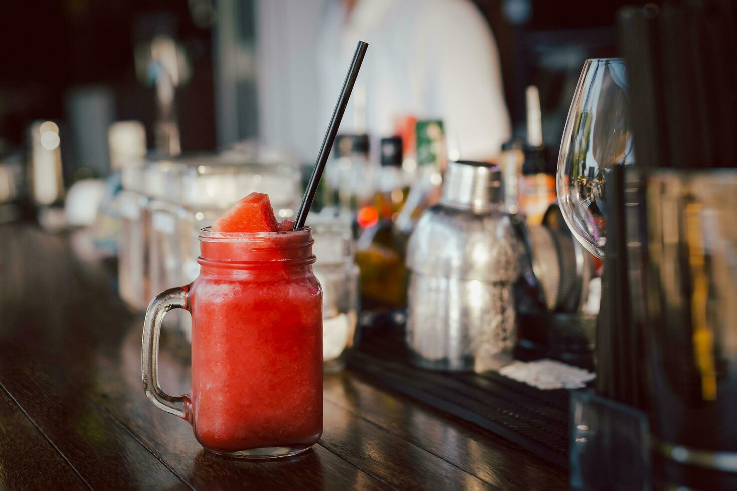 Fresh water melon smoothie in the glass jar on counter bar. photo