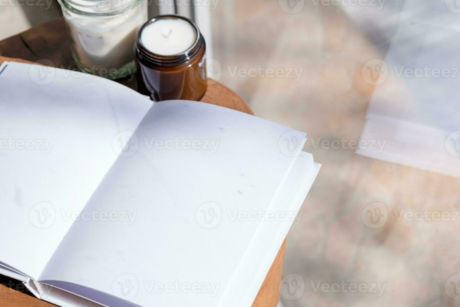 Magazine and book mockup design. Blank magazine on modern wooden table with candles , shadow overlay photo