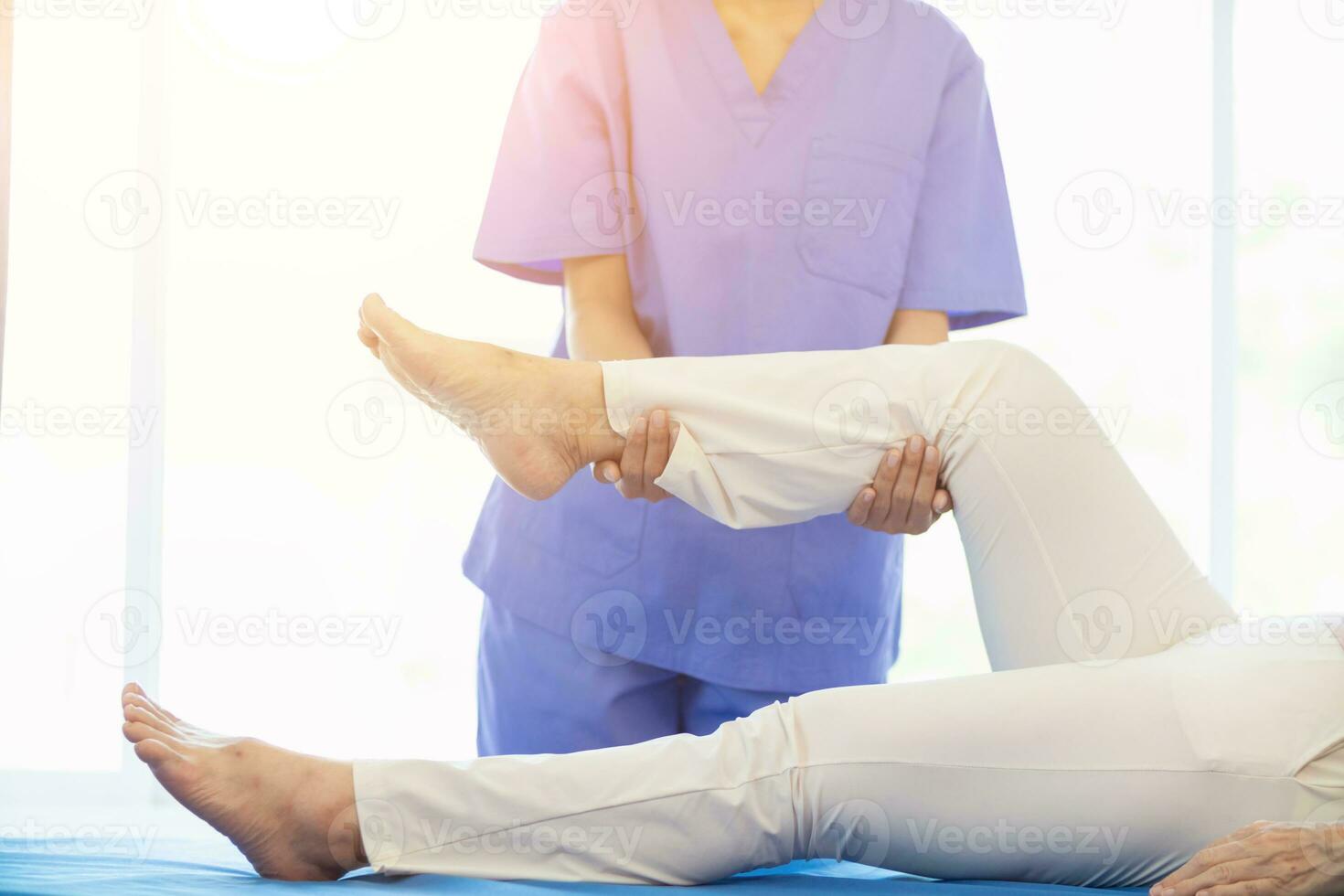 Physical therapists are helping elderly people to take care of themselves after a long period of recovery and they need regular physical therapy to help their bodies recover. physical therapy concept photo