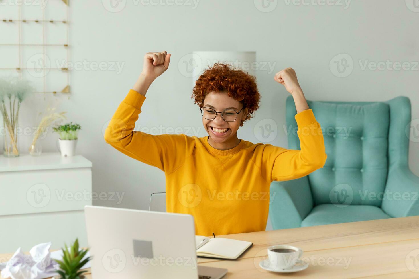 Excited happy african american woman winner. Girl female student looking at laptop passed exam reading great news getting good result winning online bid feeling amazed looking at computer at home. photo