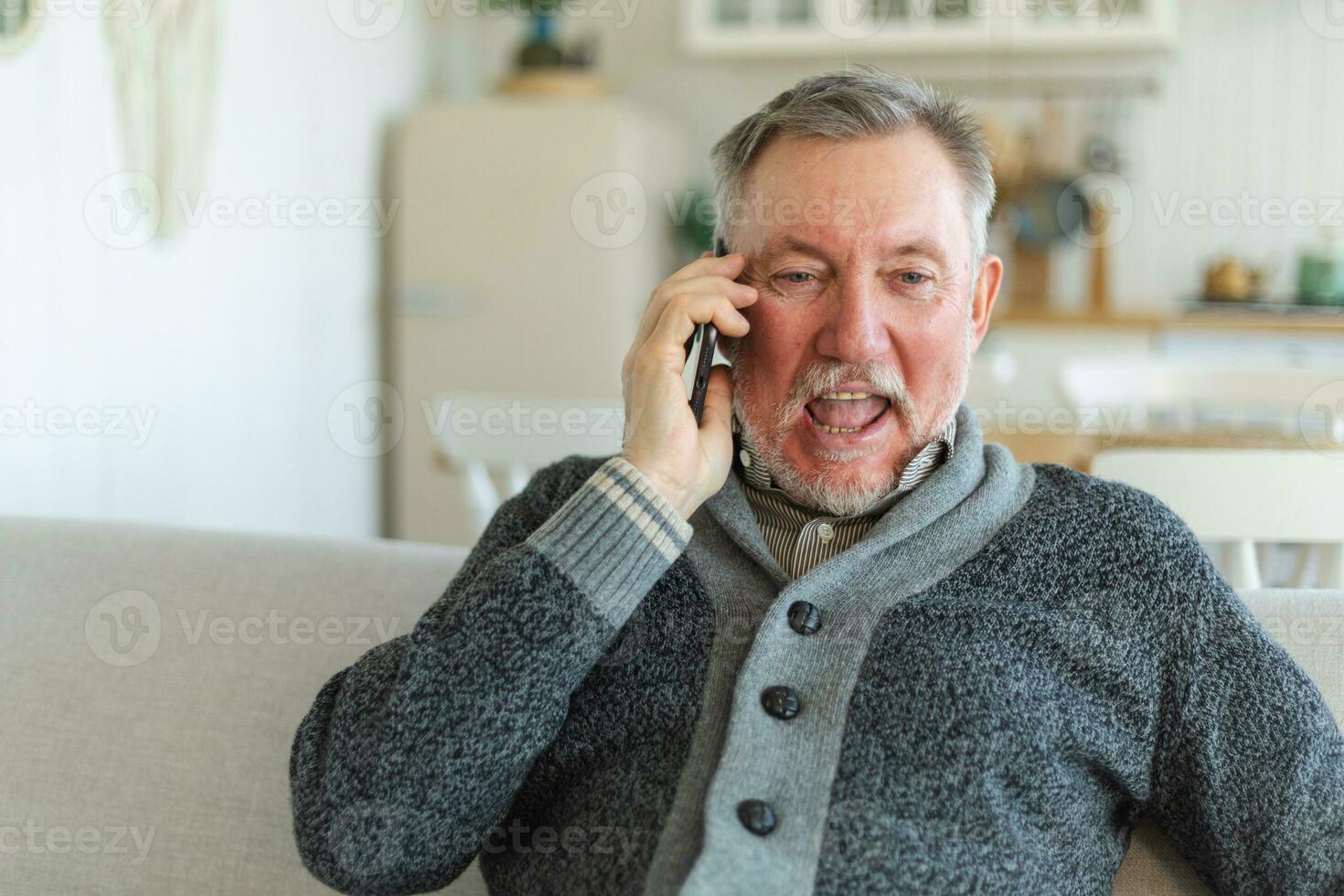 Happy middle aged senior man talking on smartphone with family friends. Older mature grandfather with cell phone talking with grown up children, resting at home. Older generation modern tech usage. photo