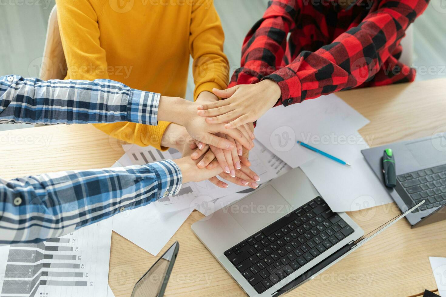 Stack of hands. Business startup teamwork unity concept. Diverse team putting their hands together top view. Young people group business colleagues sitting in office, work process success of company. photo