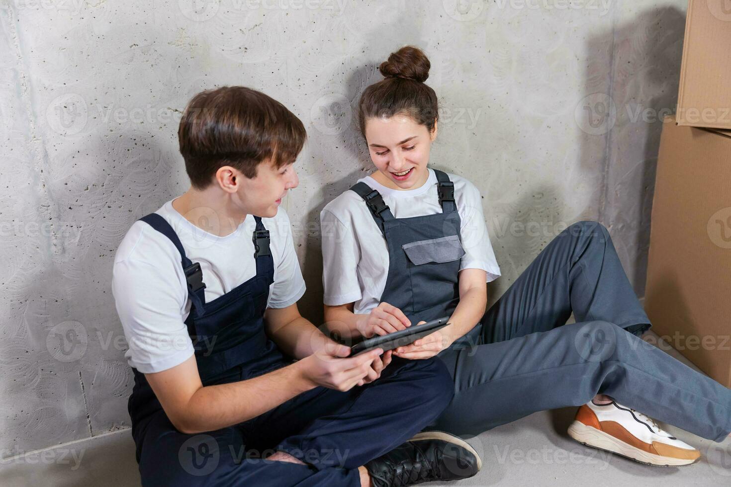 Couple in new home during repair works discussing about home design project looking repair plan on tablet. Happy family choosing new decorations and design. Home renovation DIY renew makeover concept. photo