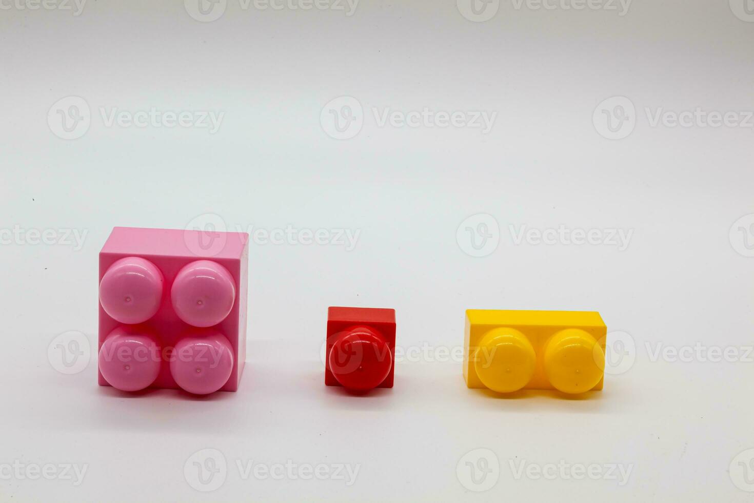 Children's toy constructor lego different sizes. Red, pink and yellow and green blocks. Photo in high quality. Isolated.