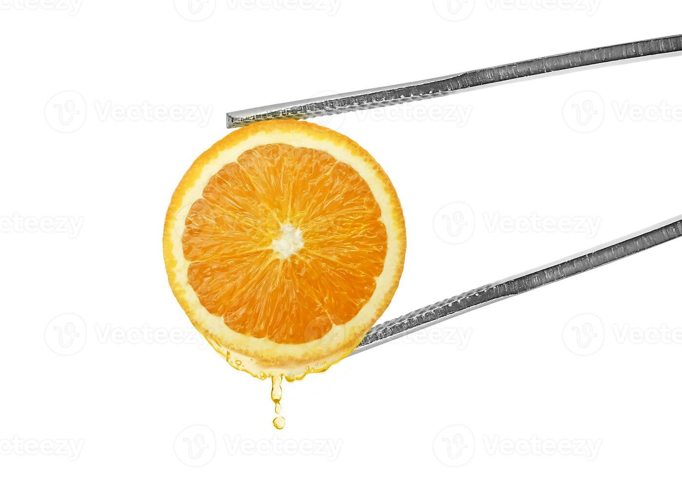 Tongs with slice. of orange juice dripping photo