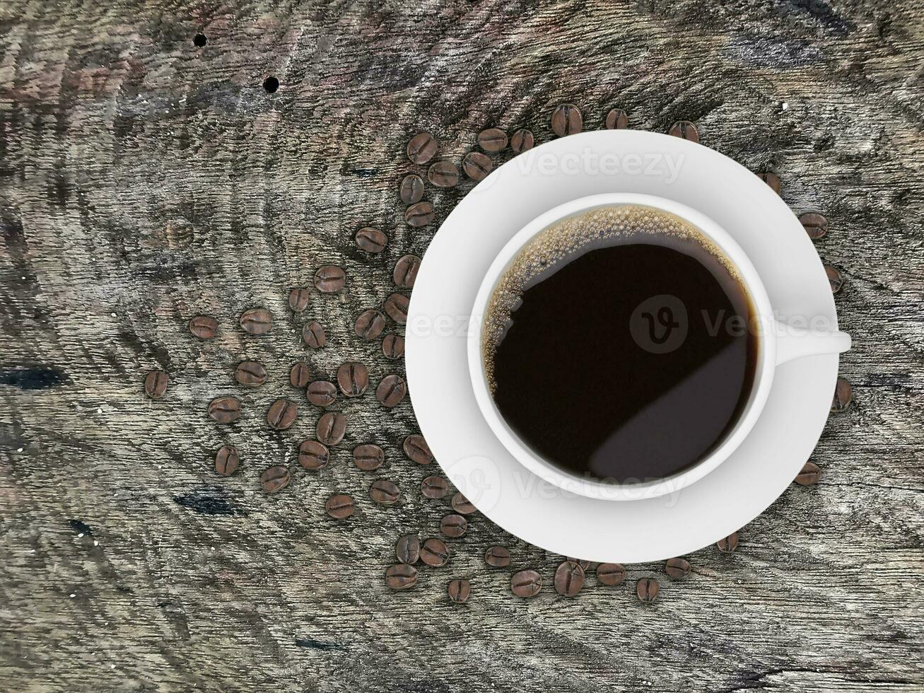 Top view of a Coffee cup and beans, on a wooden table photo
