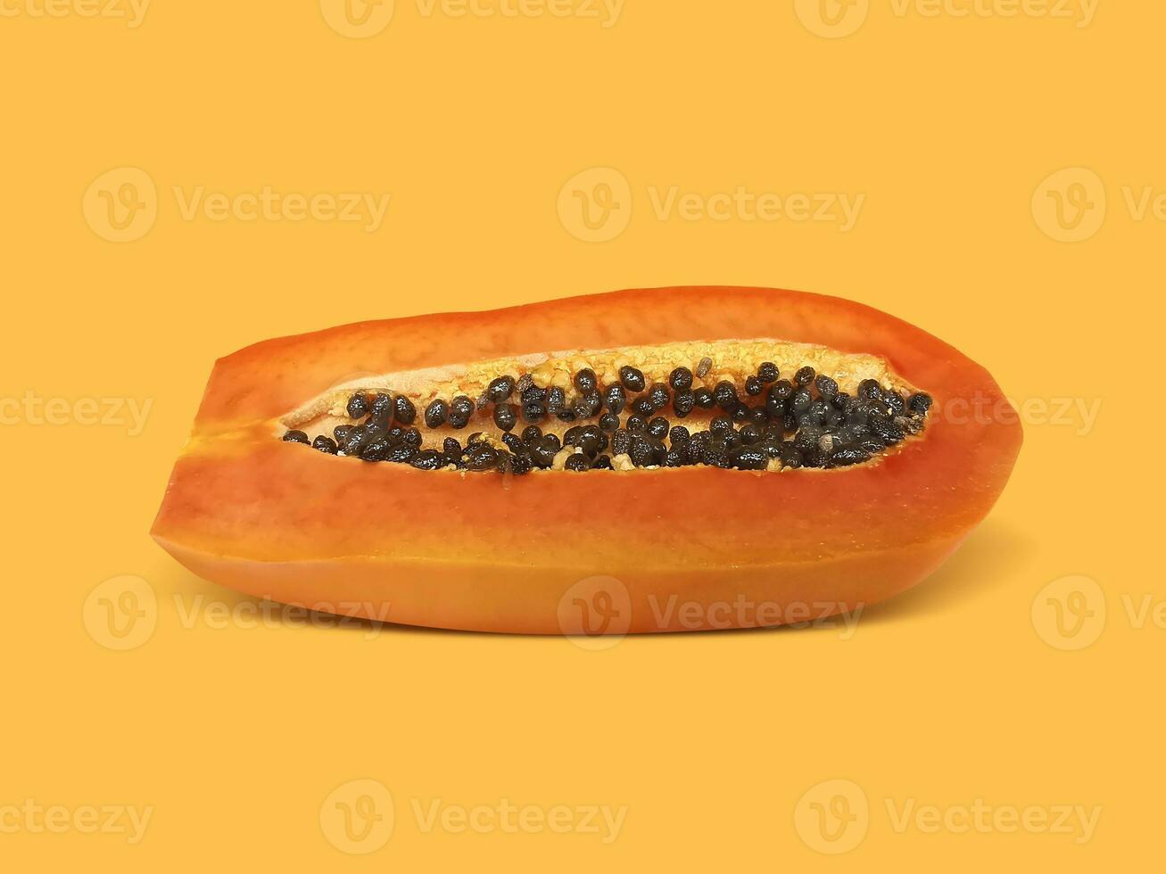 Half of ripe papaya fruit with seeds on a color background. Appetizing tropical fruit photo