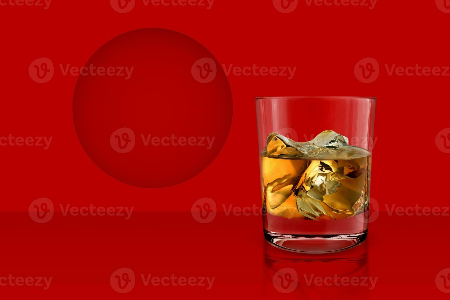 whiskey glass on red background photo